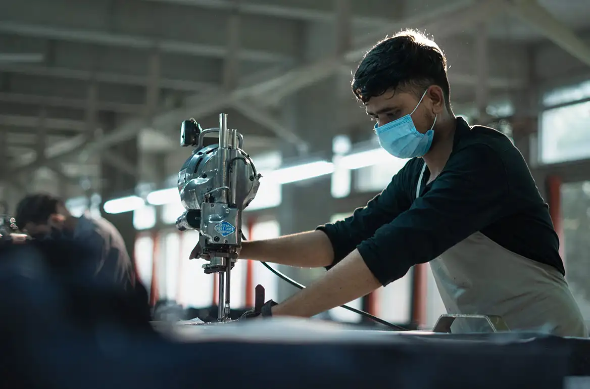 Precision fabric cutting at our FR clothing manufacturing facility